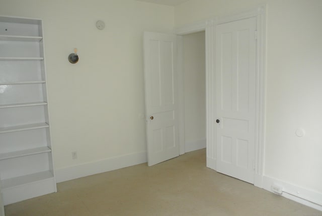 unfurnished bedroom with baseboards