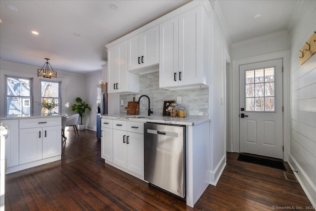 kitchen with dark wood-type flooring, appliances with stainless steel finishes, a wealth of natural light, and white cabinets