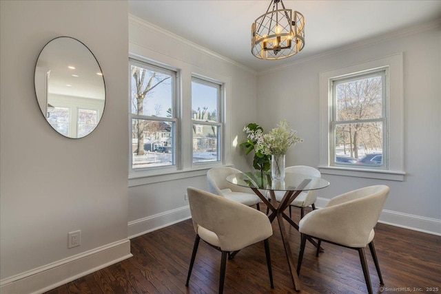 dining room with dark wood-type flooring, crown molding, and a chandelier