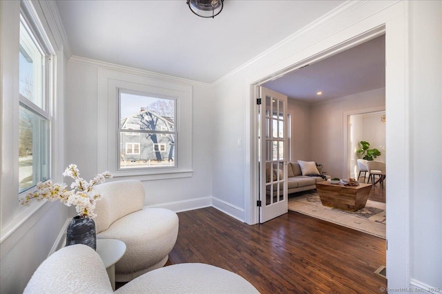 sitting room featuring ornamental molding and dark hardwood / wood-style floors