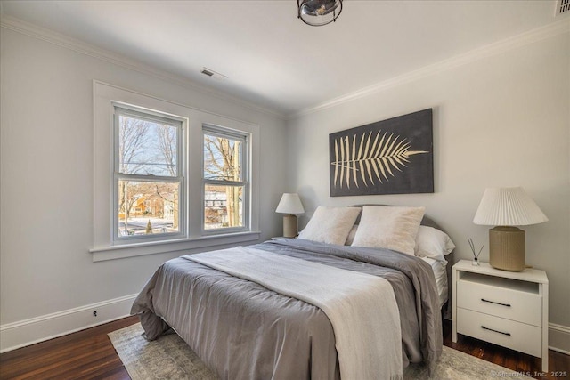 bedroom featuring ornamental molding and dark hardwood / wood-style flooring