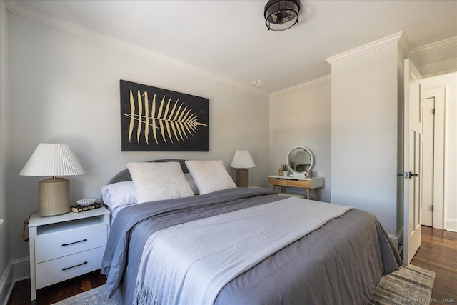 bedroom with dark wood-type flooring and ornamental molding