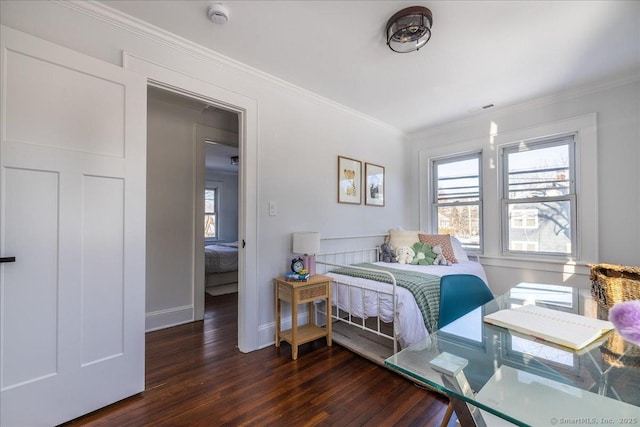 bedroom with ornamental molding and dark hardwood / wood-style flooring