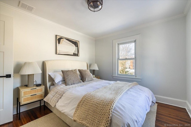 bedroom with dark wood-type flooring and crown molding