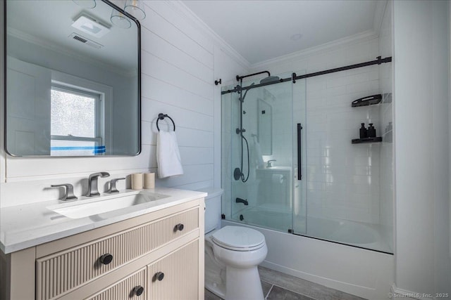 full bathroom with crown molding, vanity, shower / bath combination with glass door, and toilet