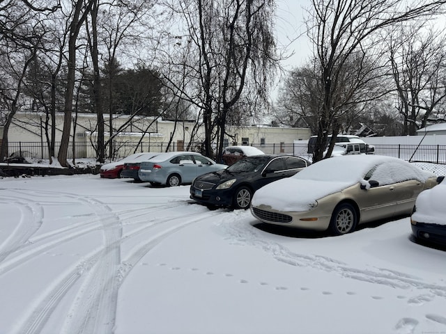 view of snow covered parking area