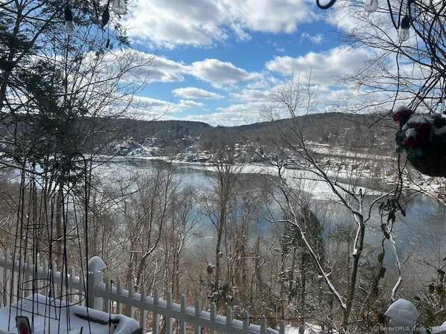 view of water feature with fence and a mountain view