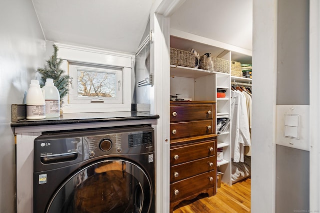 laundry area with wood finished floors, washer / clothes dryer, and laundry area