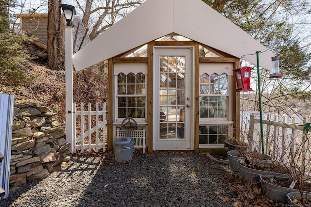 view of greenhouse featuring fence