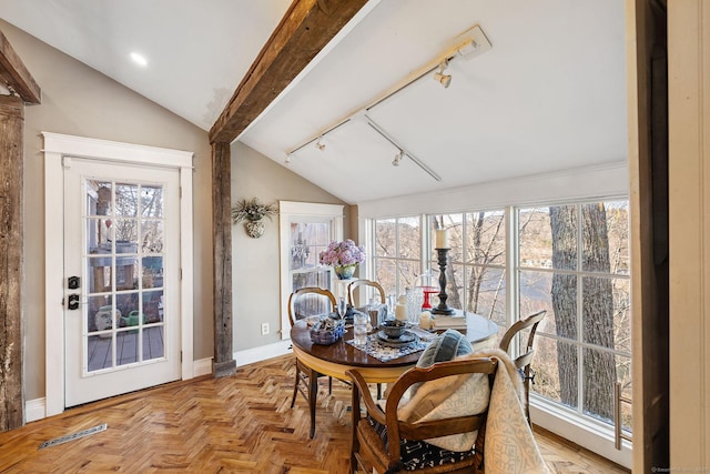 sunroom / solarium featuring rail lighting