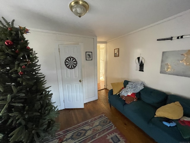 living room with dark hardwood / wood-style flooring and crown molding