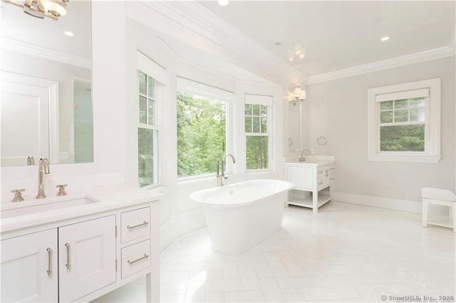 bathroom with crown molding, a notable chandelier, vanity, and a washtub