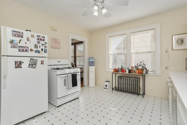 kitchen featuring white appliances, a ceiling fan, radiator heating unit, light countertops, and light floors