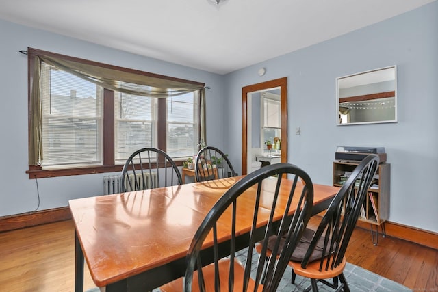 dining area with light wood finished floors and baseboards