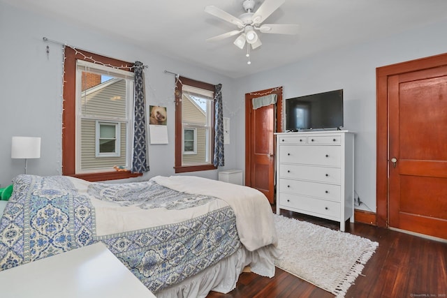 bedroom with a ceiling fan and dark wood-style flooring