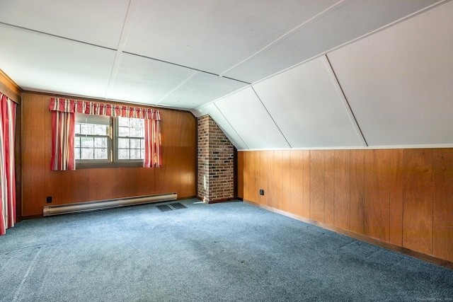 bonus room featuring vaulted ceiling, carpet floors, wood walls, visible vents, and a baseboard heating unit