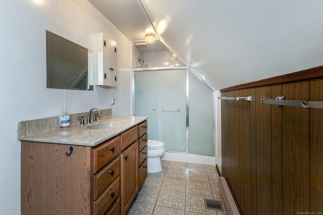 bathroom featuring vanity, vaulted ceiling, toilet, a stall shower, and visible vents
