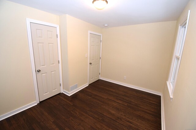 spare room with dark hardwood / wood-style flooring