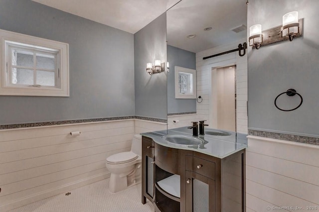 bathroom with vanity, toilet, and tile patterned flooring