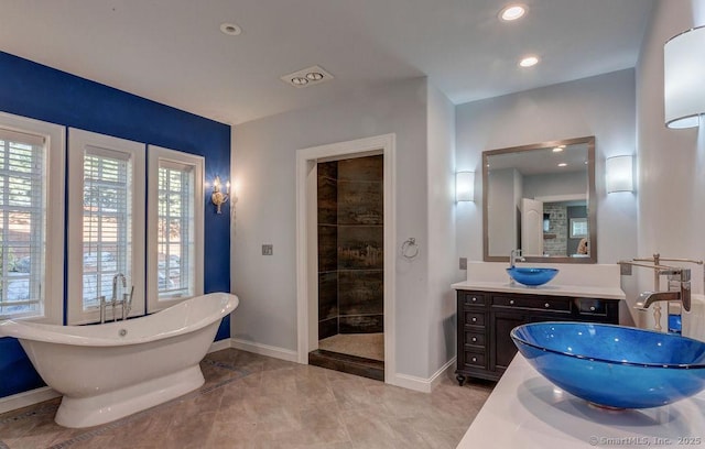 bathroom featuring vanity, separate shower and tub, and tile patterned floors