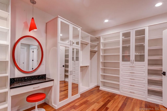 spacious closet with light hardwood / wood-style floors