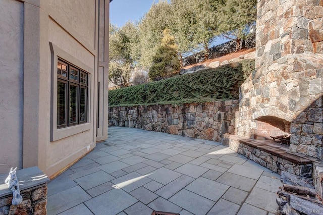 view of patio featuring a fireplace