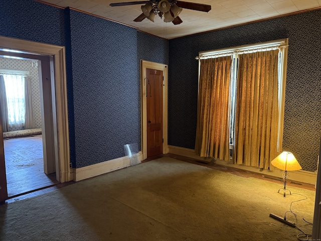 unfurnished room with baseboards, carpet flooring, and wallpapered walls