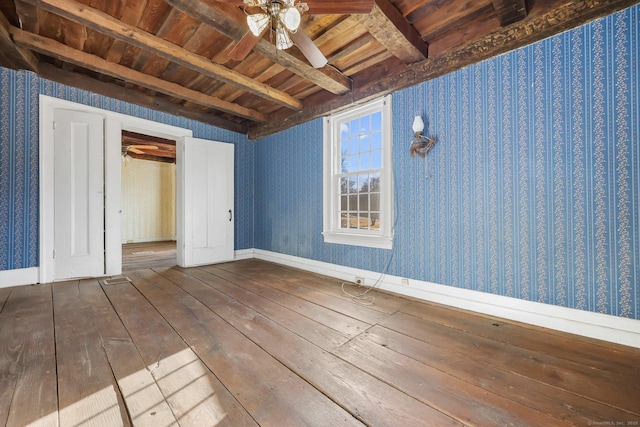 empty room with ceiling fan, wood-type flooring, beam ceiling, and wooden ceiling