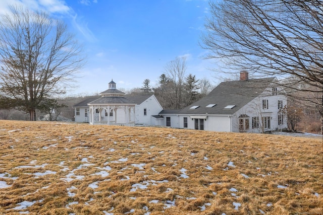 rear view of property featuring a gazebo