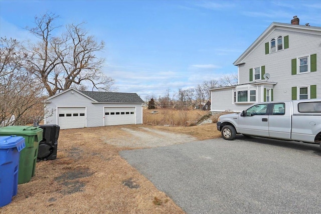 view of home's exterior with a garage and an outdoor structure