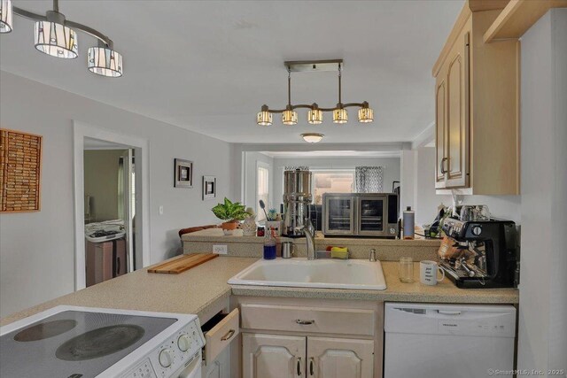 kitchen with light countertops, hanging light fixtures, stove, white dishwasher, and a sink