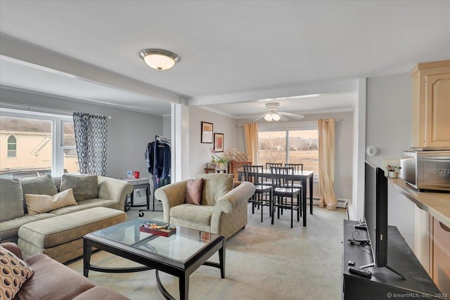 living area with light carpet and a ceiling fan