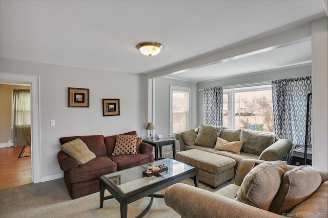 carpeted living room with baseboards