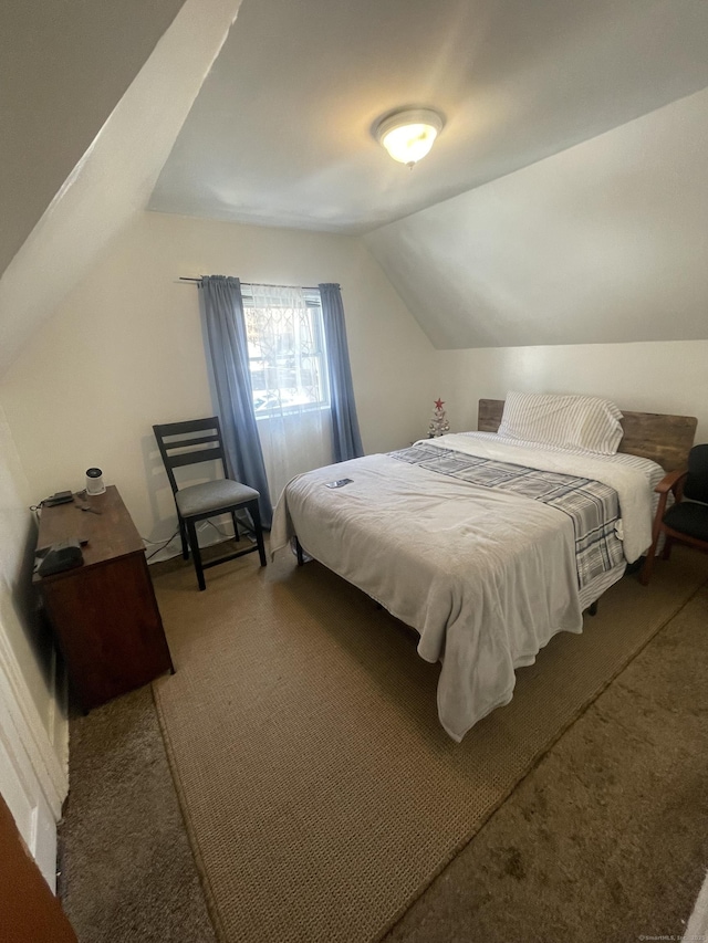 bedroom featuring lofted ceiling and carpet flooring