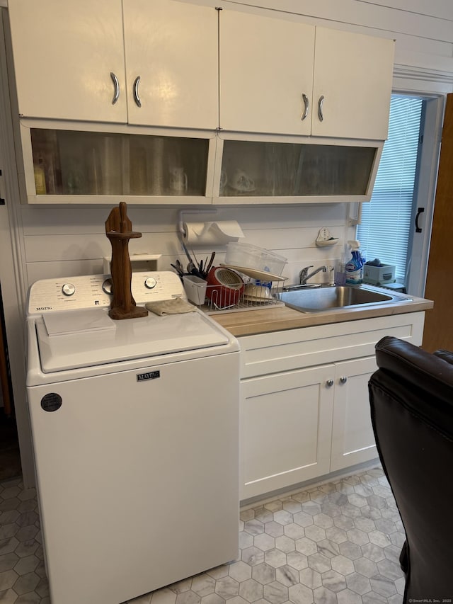 laundry room featuring a sink, cabinet space, and washer / clothes dryer