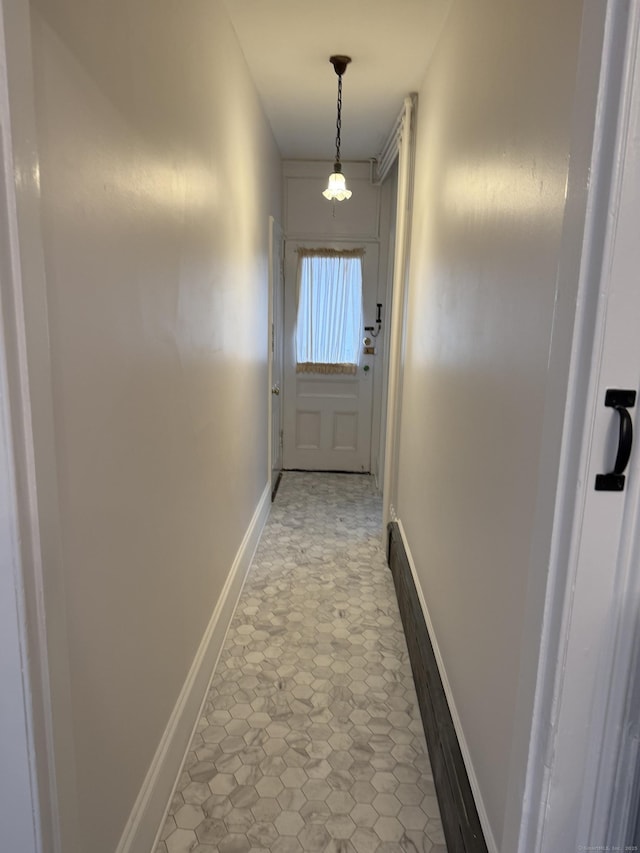 hall featuring baseboards