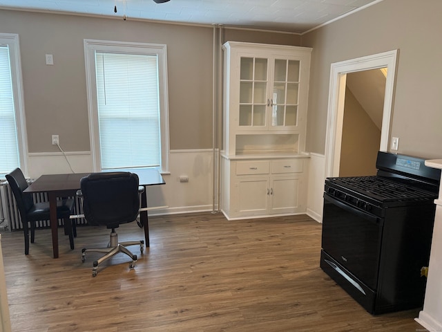 office featuring baseboards, ornamental molding, and wood finished floors