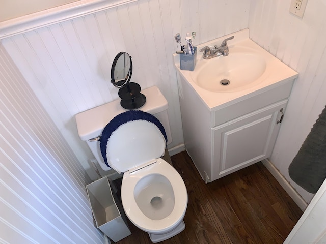 bathroom with vanity, hardwood / wood-style flooring, and toilet