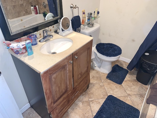 bathroom with vanity, toilet, tile patterned flooring, and a washtub