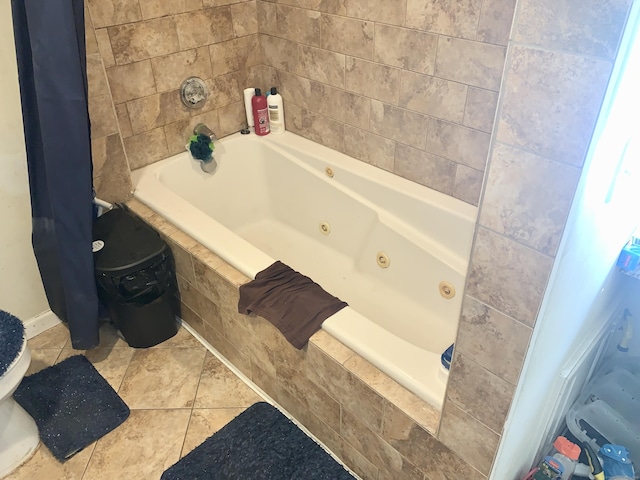 bathroom with tiled bath and tile patterned floors