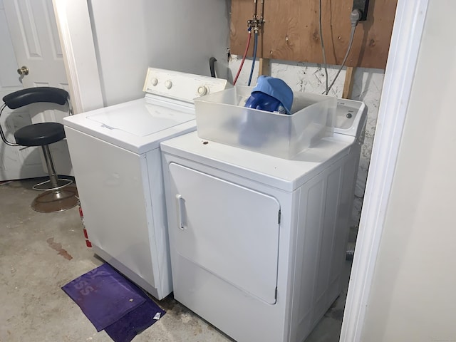 clothes washing area with separate washer and dryer