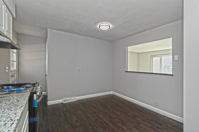 empty room featuring dark wood-type flooring