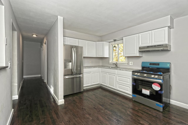 kitchen featuring under cabinet range hood, dark wood-type flooring, white cabinetry, baseboards, and appliances with stainless steel finishes