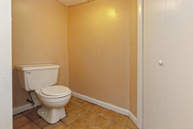 bathroom with toilet and tile patterned flooring