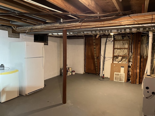 basement featuring white fridge