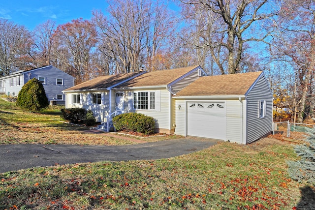 view of front of home featuring a garage and a front lawn