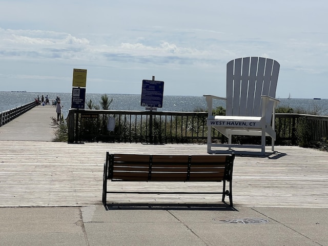 wooden terrace featuring a water view