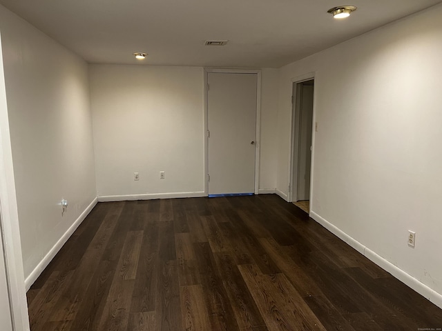 unfurnished room with dark hardwood / wood-style floors