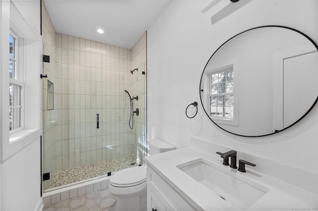 bathroom with vanity, tile patterned flooring, a shower with shower door, and toilet