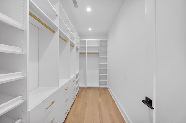 spacious closet with light hardwood / wood-style floors